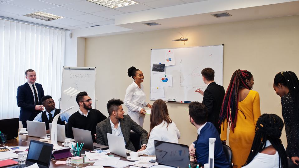 A trainer leading a session with a small group of new hires