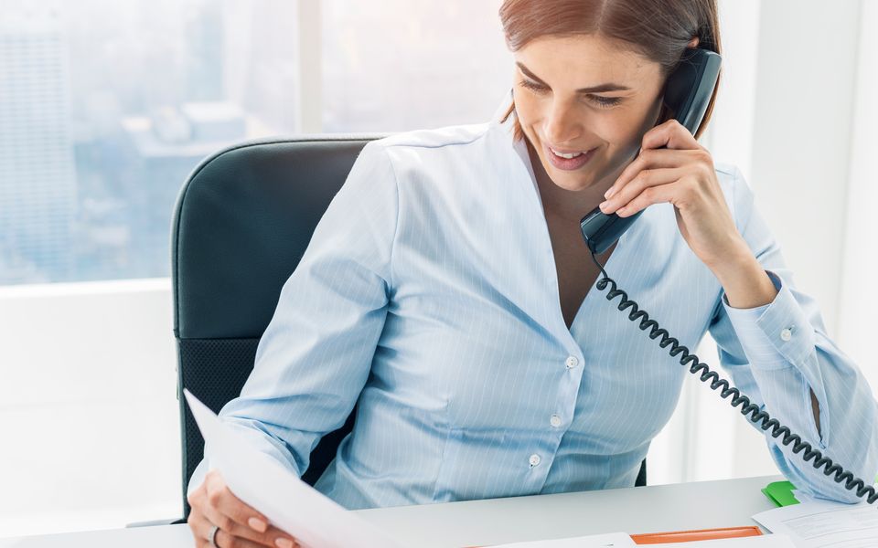 A manager on an intake phone call reviewing notes