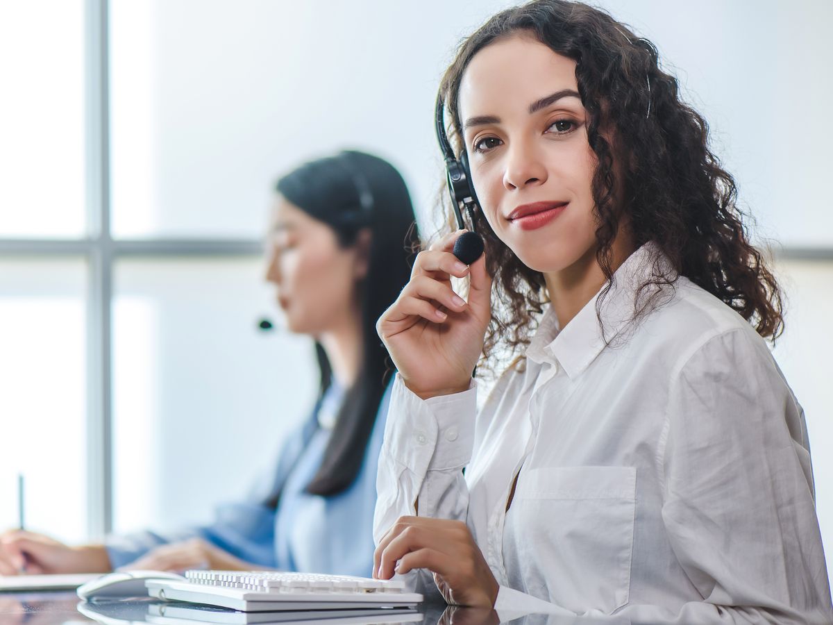 A BDC representative on a headset at her desk