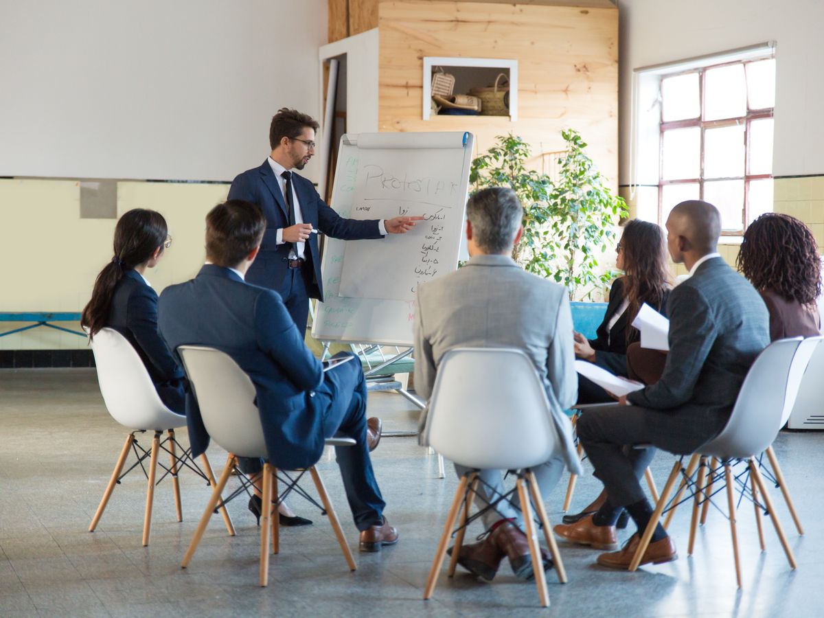 A trainer leading a team session at a flip chart